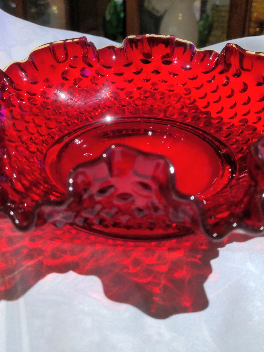Fenton Art Glass Amberina hobnail ruffled edge glass bowl. Edge glows
